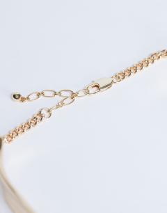 Model wearing Megan statement necklace in gold
