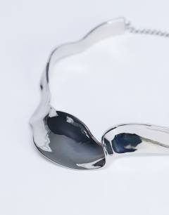 Model wearing Megan statement necklace in silver