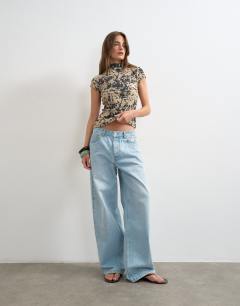 Model wearing Mesh animal cap sleeve top in cow print