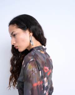 Model wearing Mesh floral print ruched long sleeve top in black