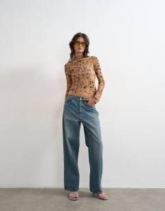 Model wearing Mesh high neck ruffle button long sleeve top in deer print