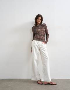 Model wearing Mesh slash neck long sleeve top in polka dot