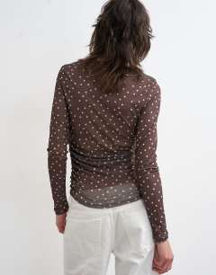 Model wearing Mesh slash neck long sleeve top in polka dot
