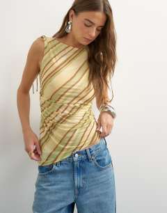 Model wearing Mesh stripe ruched shoulder asymmetric top in brown
