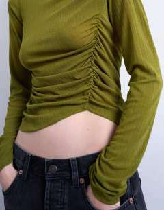 Model wearing Mesh twisted draped long sleeve top in olive green