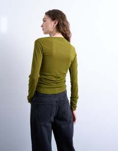 Model wearing Mesh twisted draped long sleeve top in olive green