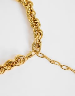 Model wearing Mia twist necklace in gold