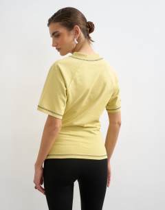 Model wearing Micro v-neck ruched side graphic tee in yellow