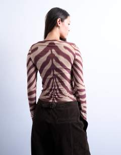 Model wearing Microfibre long sleeve zebra print top in brown