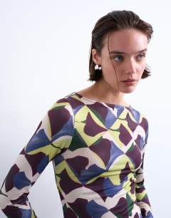 Model wearing Microfibre painted geo print long sleeve top in multi