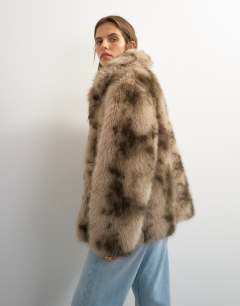 Model wearing Mid length faux fur jacket in brown speckle
