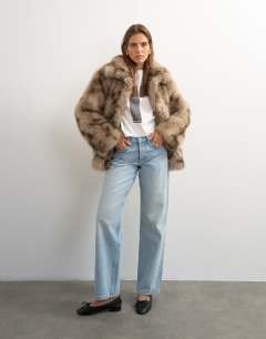 Model wearing Mid length faux fur jacket in brown speckle