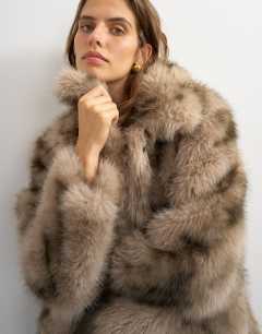 Model wearing Mid length faux fur jacket in brown speckle