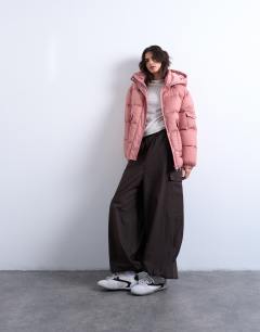 Model wearing Mid length funnel neck puffer jacket in pink