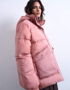 Model wearing Mid length funnel neck puffer jacket in pink
