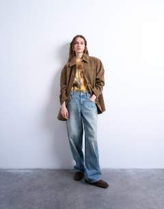 Model wearing Mid length high break faux suede jacket in brown