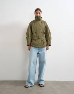 Model wearing Mid length oversized belted trench in green