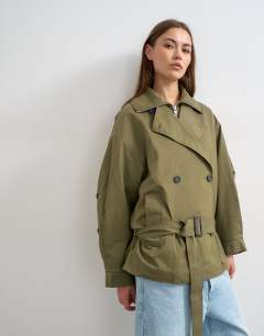 Model wearing Mid length oversized belted trench in green