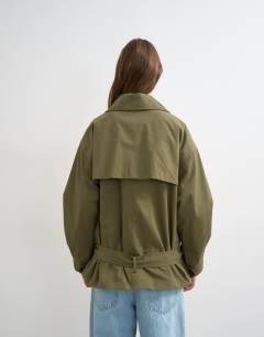 Model wearing Mid length oversized belted trench in green