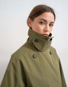 Model wearing Mid length oversized belted trench in green