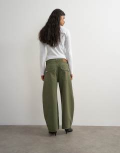Model wearing Mid rise baggy arc jean in khaki