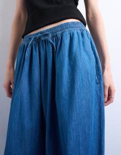 Model wearing Mid rise balloon jean in mid blue