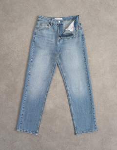 Model wearing Mid rise comfort straight jean in bleach