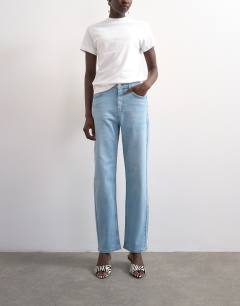 Model wearing Mid rise comfort straight jean in light bleach