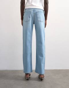 Model wearing Mid rise comfort straight jean in light bleach