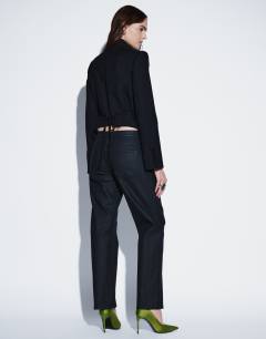 Model wearing Mid rise slim straight coated jean in black
