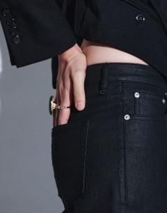 Model wearing Mid rise slim straight coated jean in black