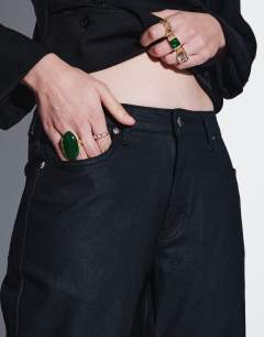 Model wearing Mid rise slim straight coated jean in black