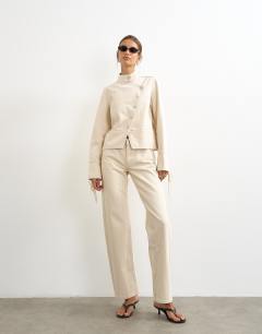 Model wearing Mid rise straight leg jean with lace up detail in oat