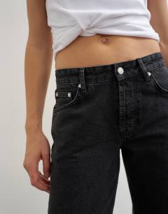 Model wearing Mid rise straight leg jean with lace up detail in washed black
