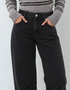 Model wearing Mid rise straight leg jean with lace up detail in washed black