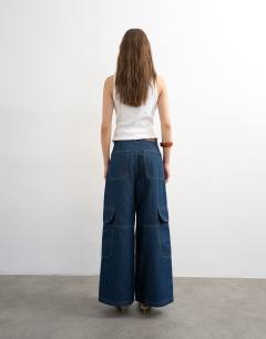 Model wearing Mid rise wide leg jean with utility pocket detail in indigo rinse
