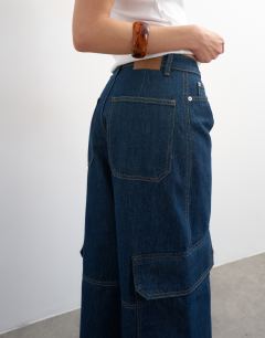Model wearing Mid rise wide leg jean with utility pocket detail in indigo rinse