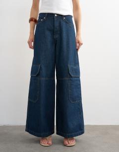 Model wearing Mid rise wide leg jean with utility pocket detail in indigo rinse