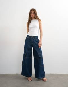 Model wearing Mid rise wide leg jean with utility pocket detail in indigo rinse