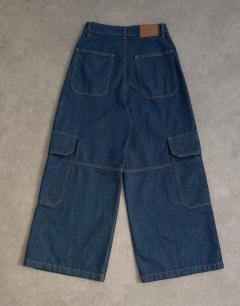 Model wearing Mid rise wide leg jean with utility pocket detail in indigo rinse