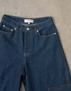 Model wearing Mid rise wide leg jean with utility pocket detail in indigo rinse