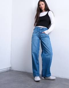 Model wearing Mid rise yoke front cinch jean in vintage blue