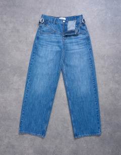 Model wearing Mid rise yoke front cinch jean in vintage blue