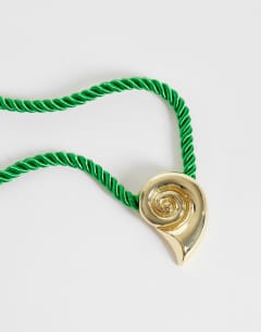 Model wearing Mika rope choker with shell pendant in green and gold
