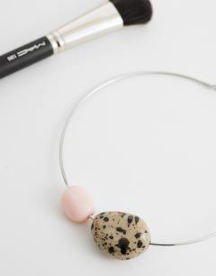 Model wearing Mila choker necklace with pink and dalmatian stones