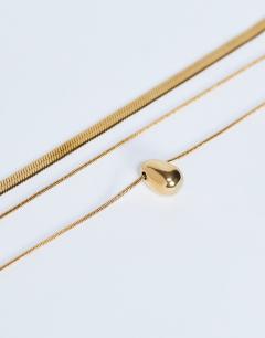Model wearing Mila waterproof stainless steel 2 pack snake chain necklace in gold