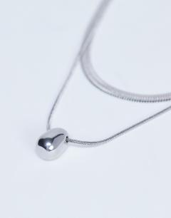 Model wearing Mila waterproof stainless steel 2 pack snake chain necklace in silver