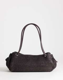 Model wearing Miller large straw shoulder bag in chocolate