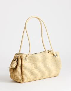 Model wearing Miller large straw shoulder bag in natural