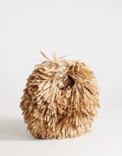 Model wearing Milo medium straw fringe grab bag in natural